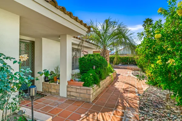 a house with potted plants in front of it