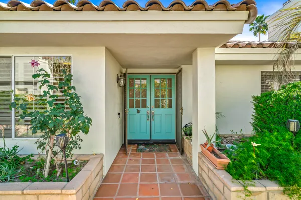 a house with potted plants in front of it