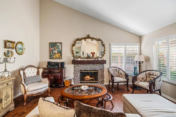 a kitchen with stainless steel appliances granite countertop a table and chairs