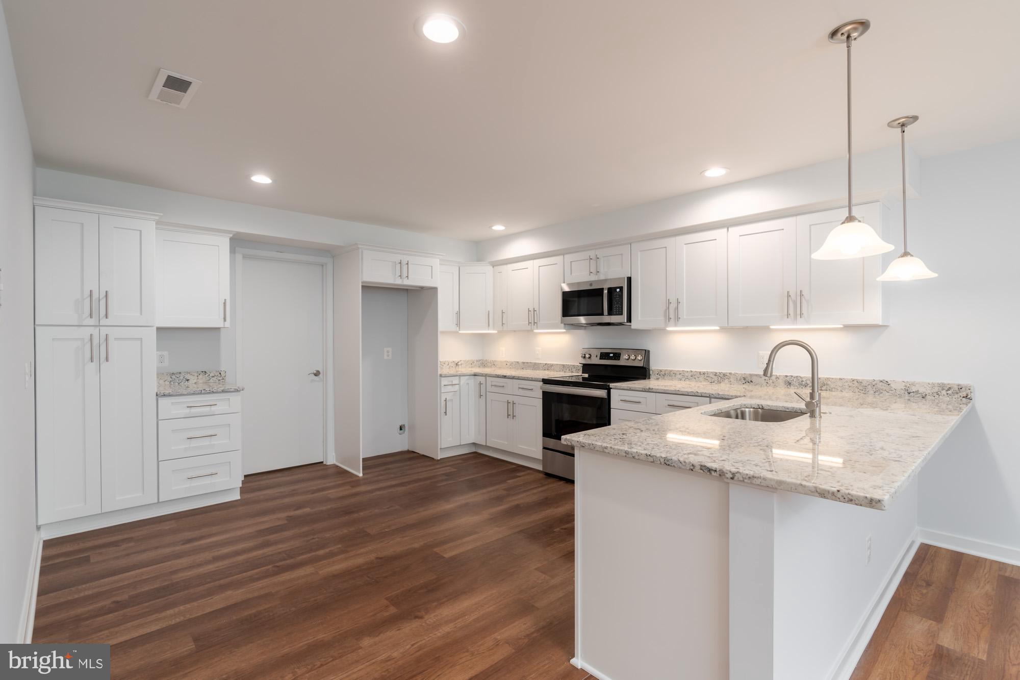 11500 Fairway Drive, Unit 401 Reston, VA 20190 - Photo 3 of 36 New Kitchen with granite and soft close cabinetry