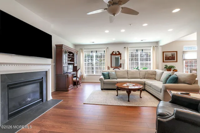 a living room with furniture a fireplace and a flat screen tv