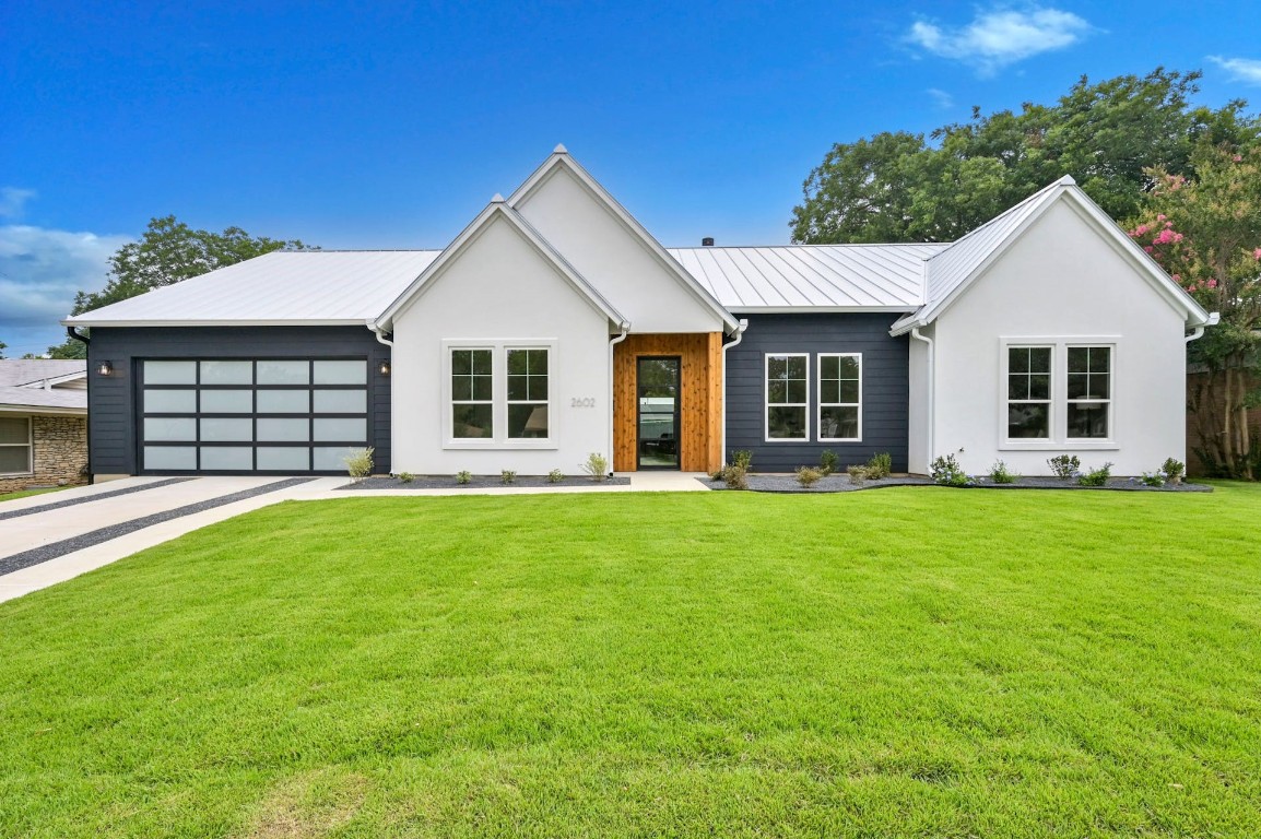 a view of a house with a backyard