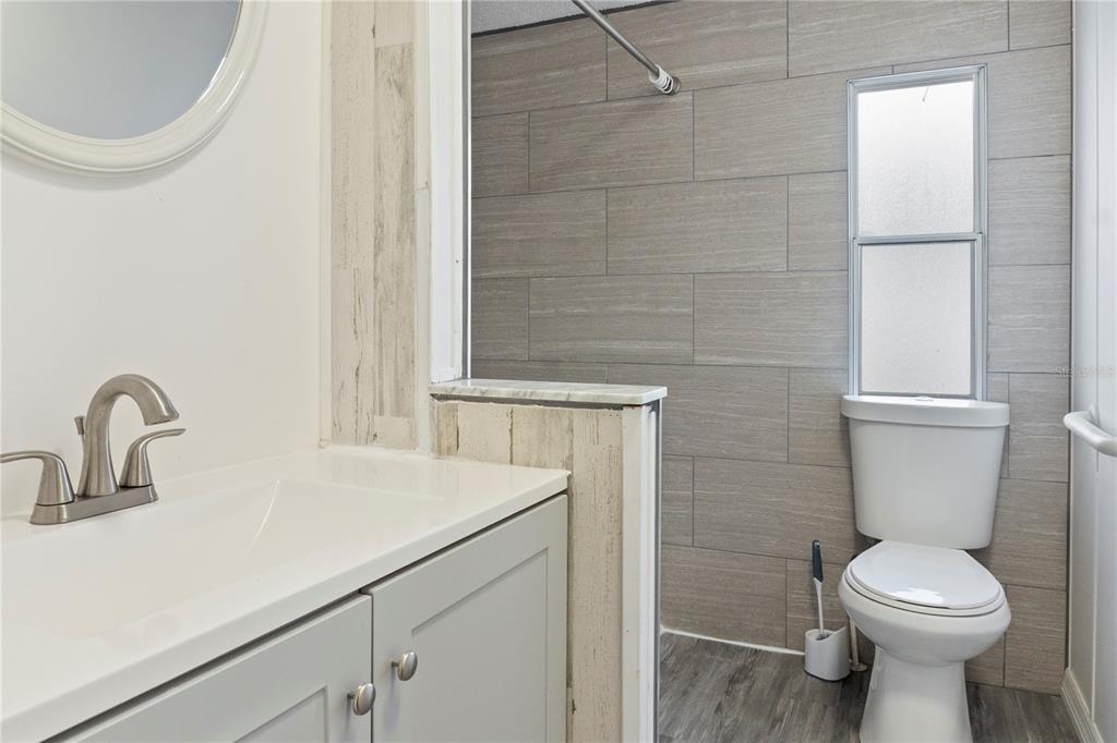 6526 Jack Street Punta Gorda, FL 33982 - Photo 14 of 19 a bathroom with a sink a toilet and a mirror