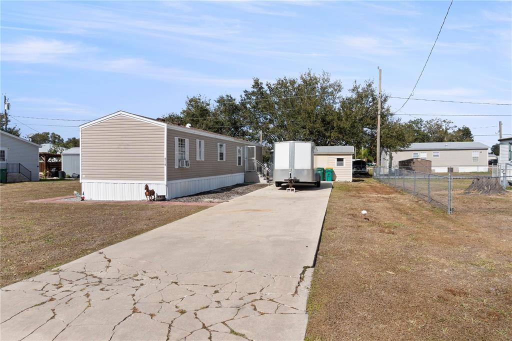 6526 Jack Street Punta Gorda, FL 33982 - Photo 2 of 19 a street view with a house