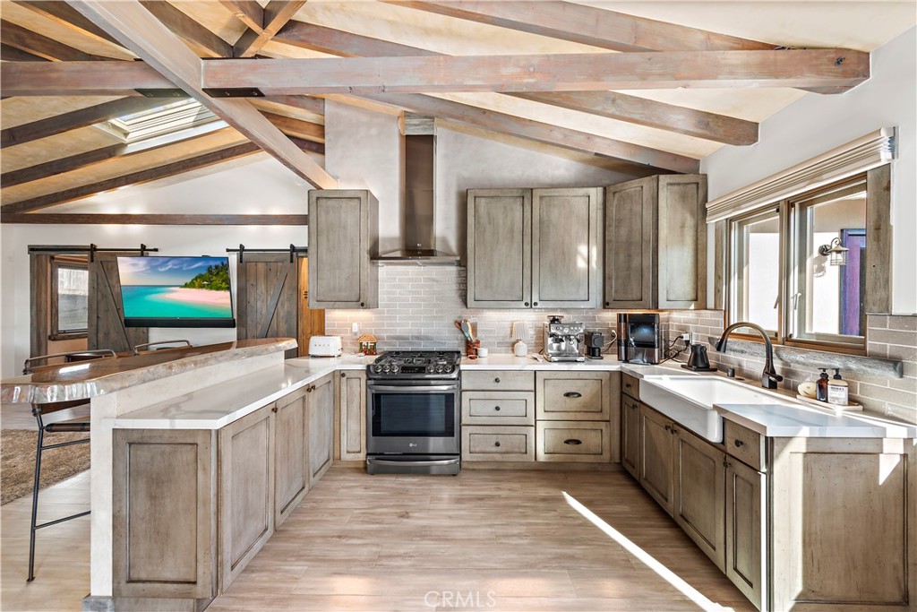 1209 C. Toledo San Clemente, CA 92672 - Photo 13 of 47 a hall with stainless steel appliances granite countertop a stove and cabinets