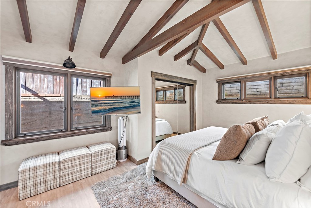 1209 C. Toledo San Clemente, CA 92672 - Photo 27 of 47 a bedroom with a bed a couch and a potted plant on the dresser