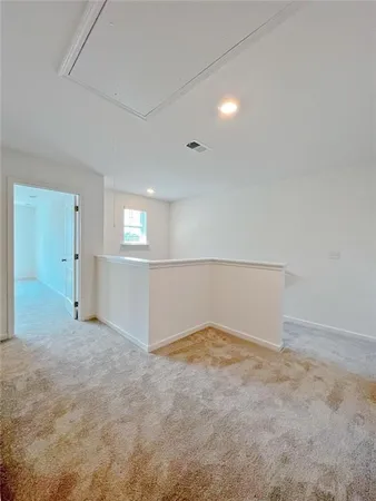 an empty room with windows and entrance to other room