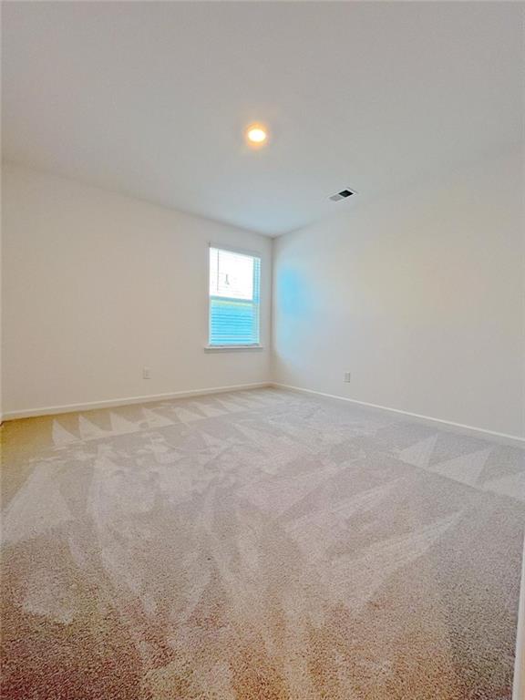 117 Goshawk Street Braselton, GA 30517 - Photo 16 of 28 a view of an empty room with a window