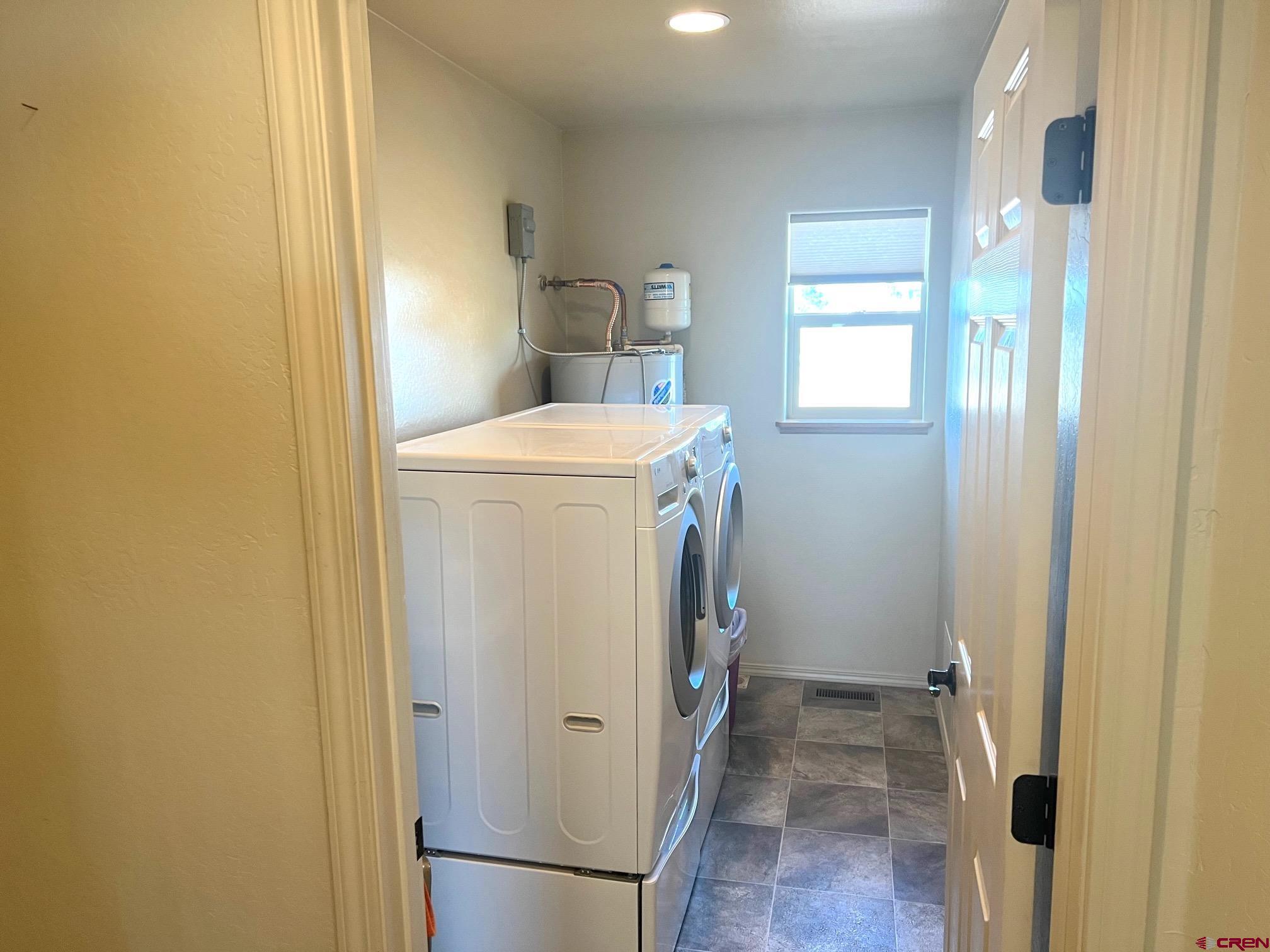 930 Bluffs Boulevard Cortez, CO 81321 - Photo 20 of 28 a utility room with dryer and washer