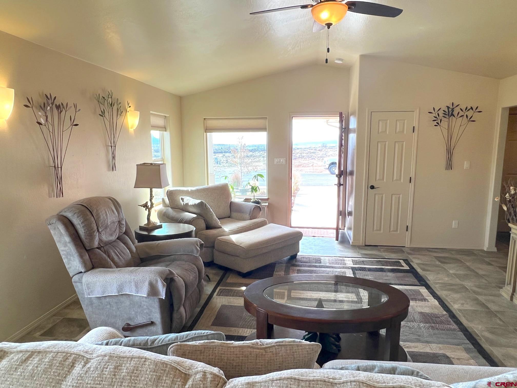 930 Bluffs Boulevard Cortez, CO 81321 - Photo 9 of 28 a living room with furniture and a large window
