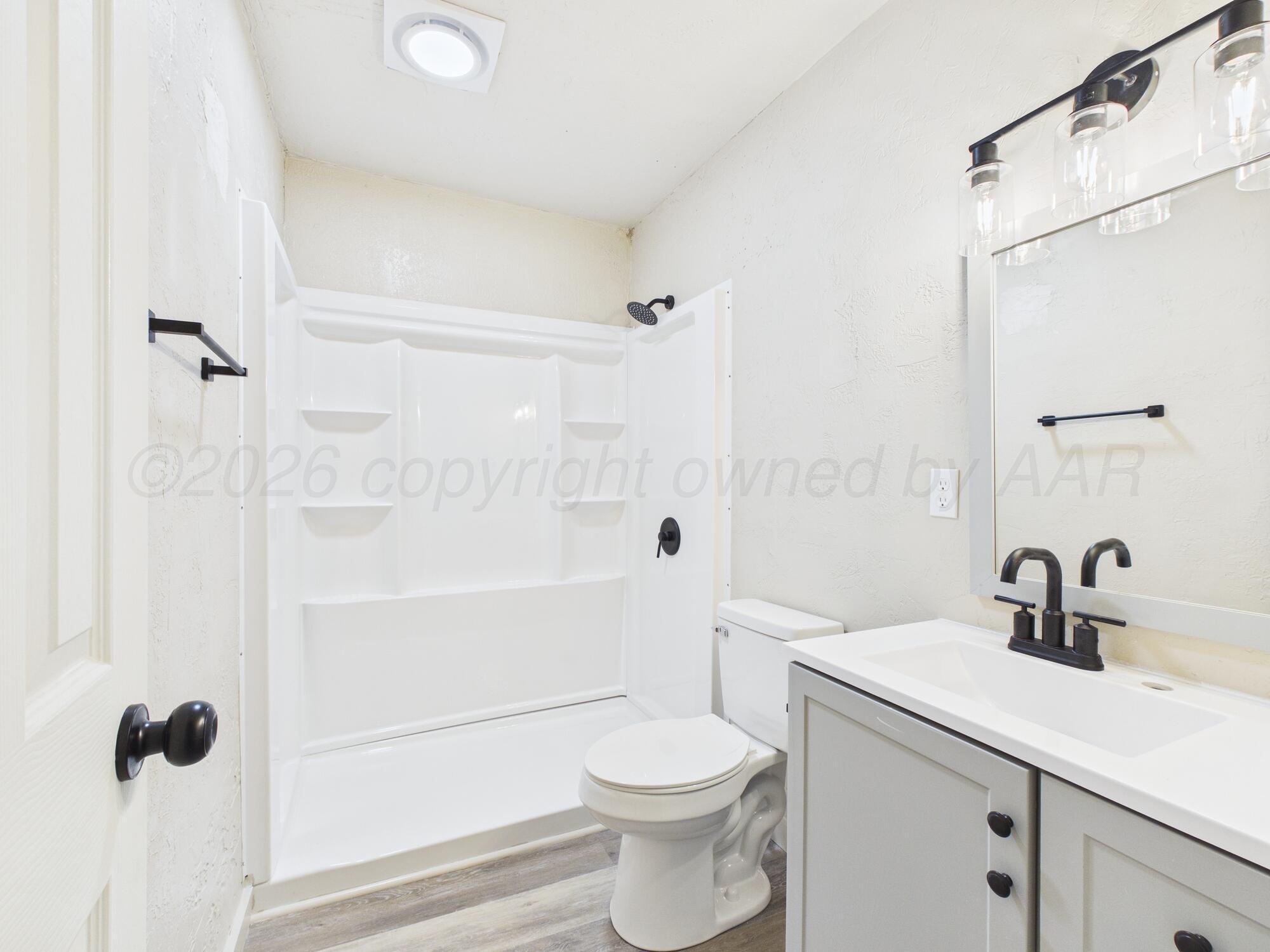 1111 Southwest 13th Avenue Amarillo, TX 79102 - Photo 15 of 20 a bathroom with a sink a toilet and shower