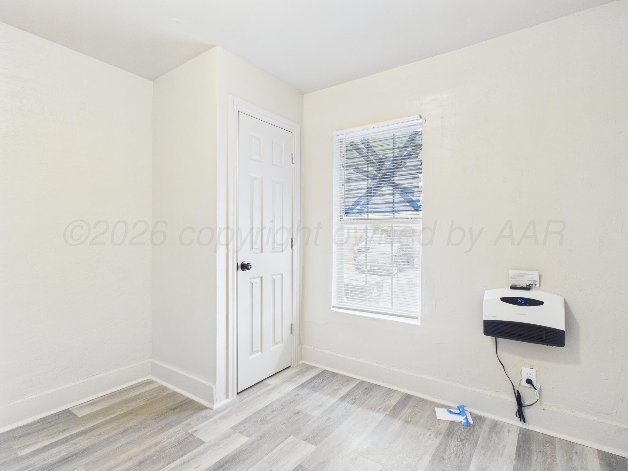 1111 Southwest 13th Avenue Amarillo, TX 79102 - Photo 7 of 20 a view of an empty room with wooden floor and a window