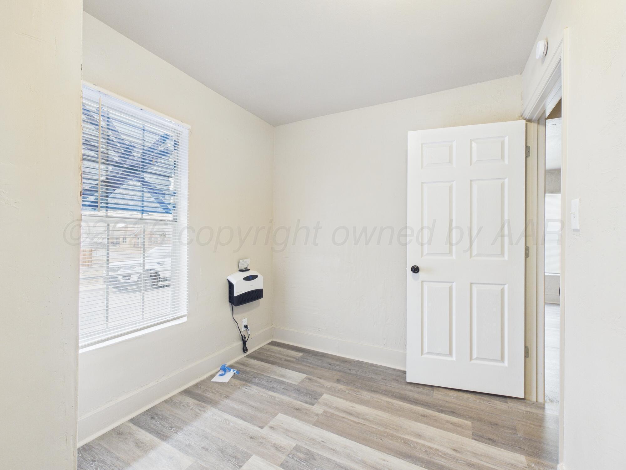 1111 Southwest 13th Avenue Amarillo, TX 79102 - Photo 8 of 20 a view of empty room with wooden floor and fan