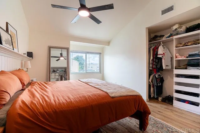a bedroom with a large bed and a window