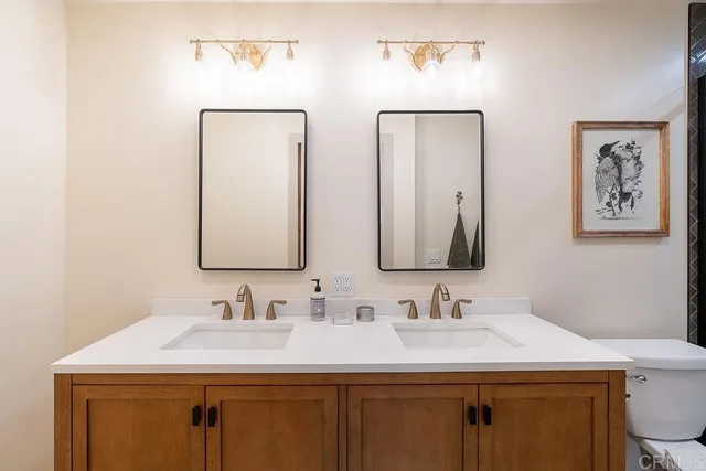 a bathroom with 2 sink and a mirror
