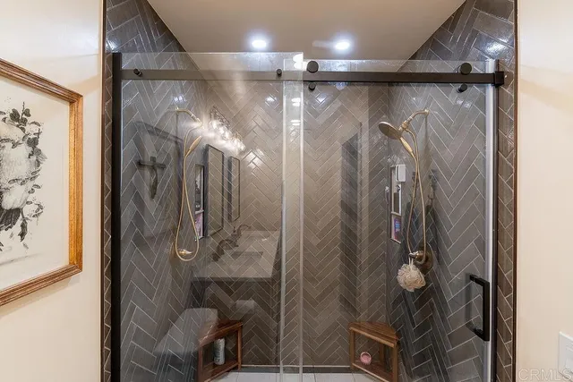 a bathroom with double vanity sinks and a mirror
