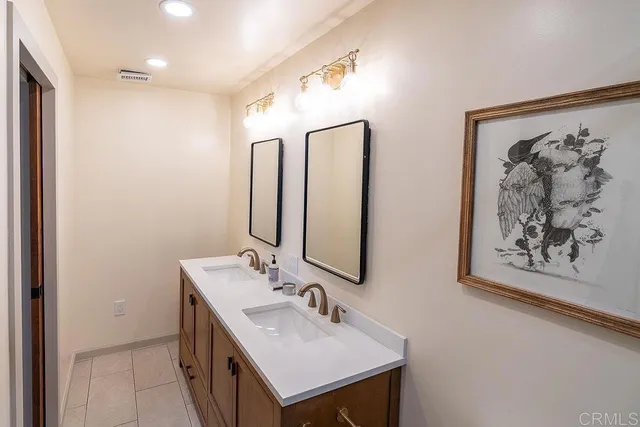 a bathroom with a sink vanity and mirror