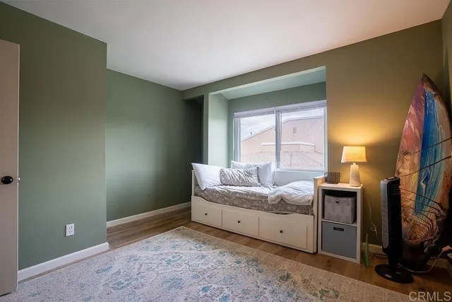 a view of a room with workspace and a flat screen tv