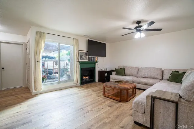 a view of a livingroom with a fireplace and staircase