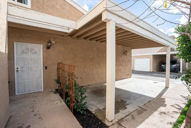 a kitchen with a dining table chairs and refrigerator