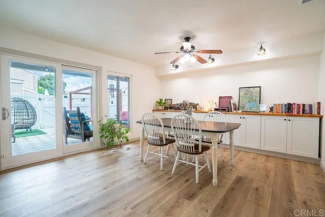 a dining room with furniture and wooden floor