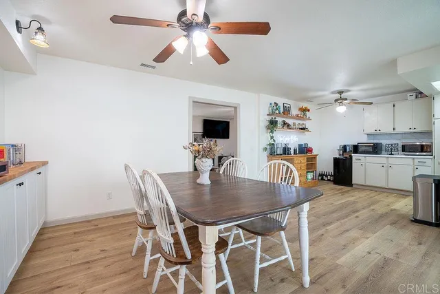 a dining room with furniture and window