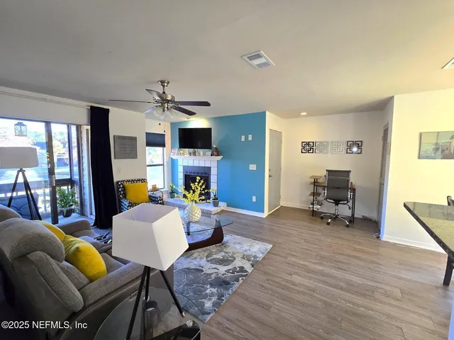 a living room with furniture and a wooden floor
