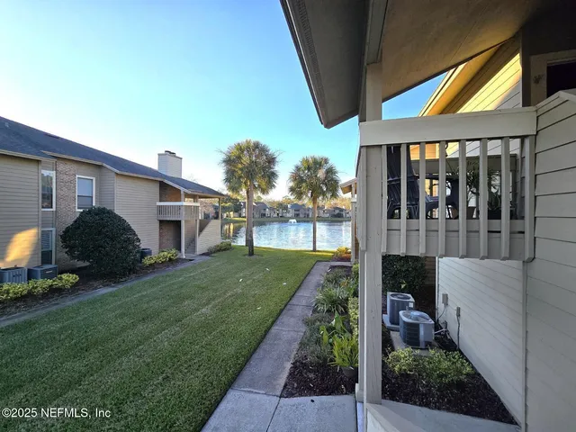 a view of a house with backyard and porch
