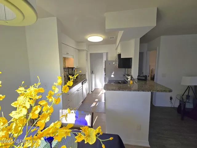 a living room with furniture and flowers