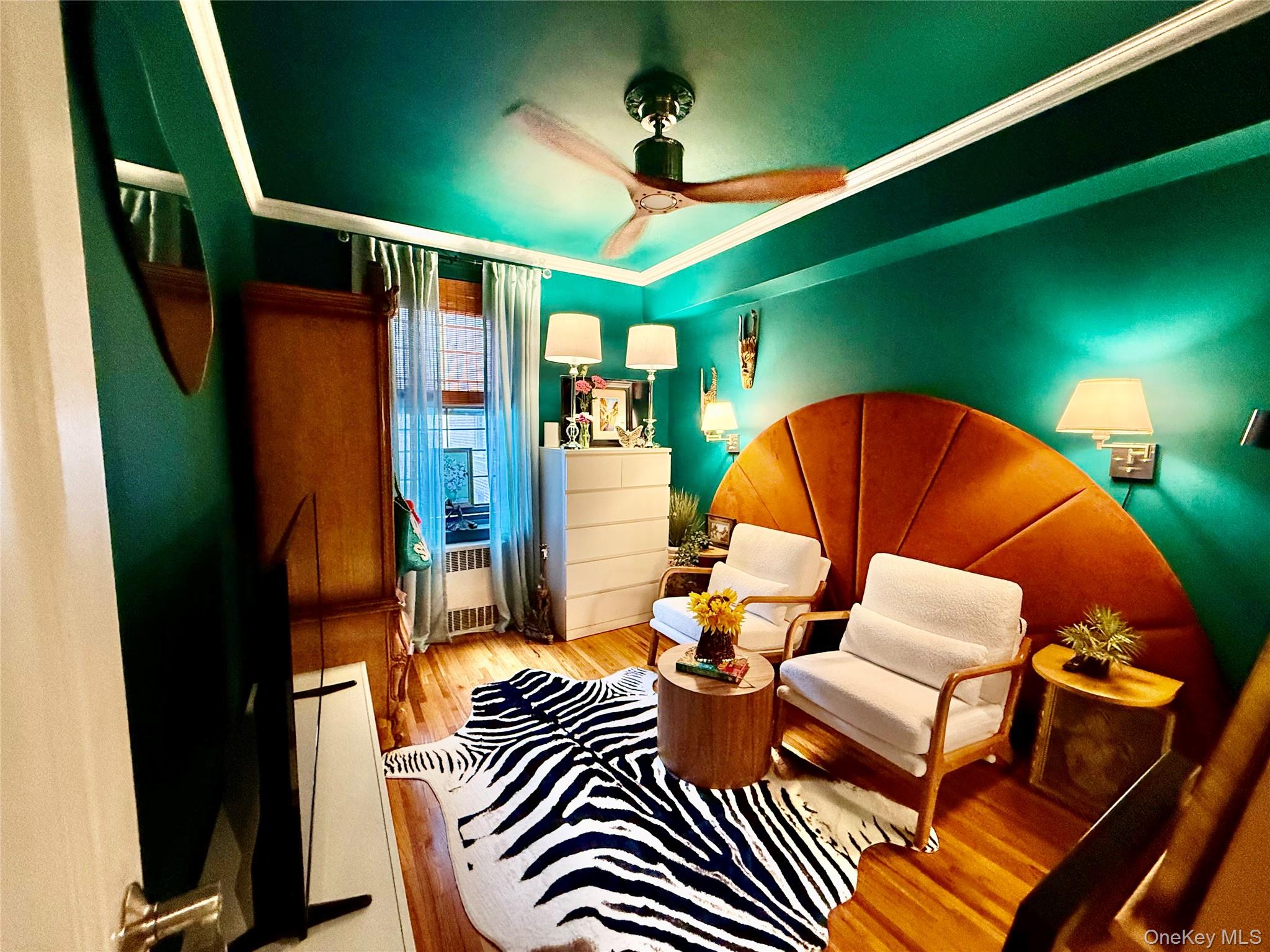 112-25 34th Avenue, Unit 2D Queens, NY 11368 - Photo 14 of 37 a living room with furniture and a wooden floor