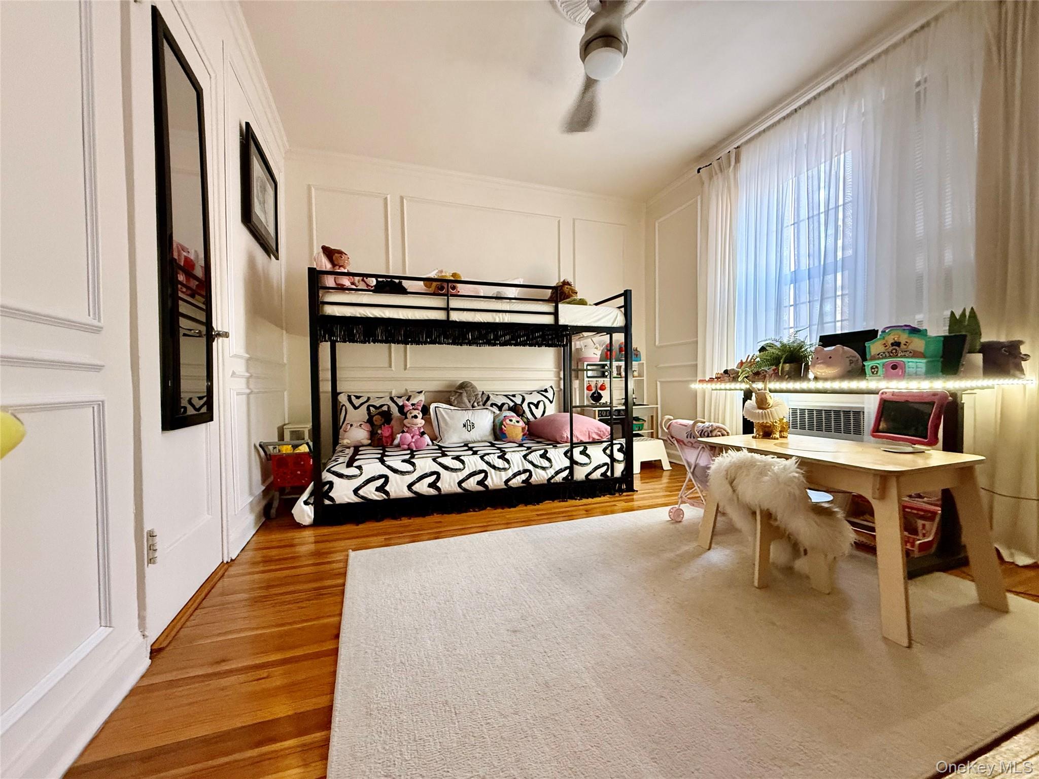 112-25 34th Avenue, Unit 2D Queens, NY 11368 - Photo 16 of 37 a living room with furniture and a chandelier