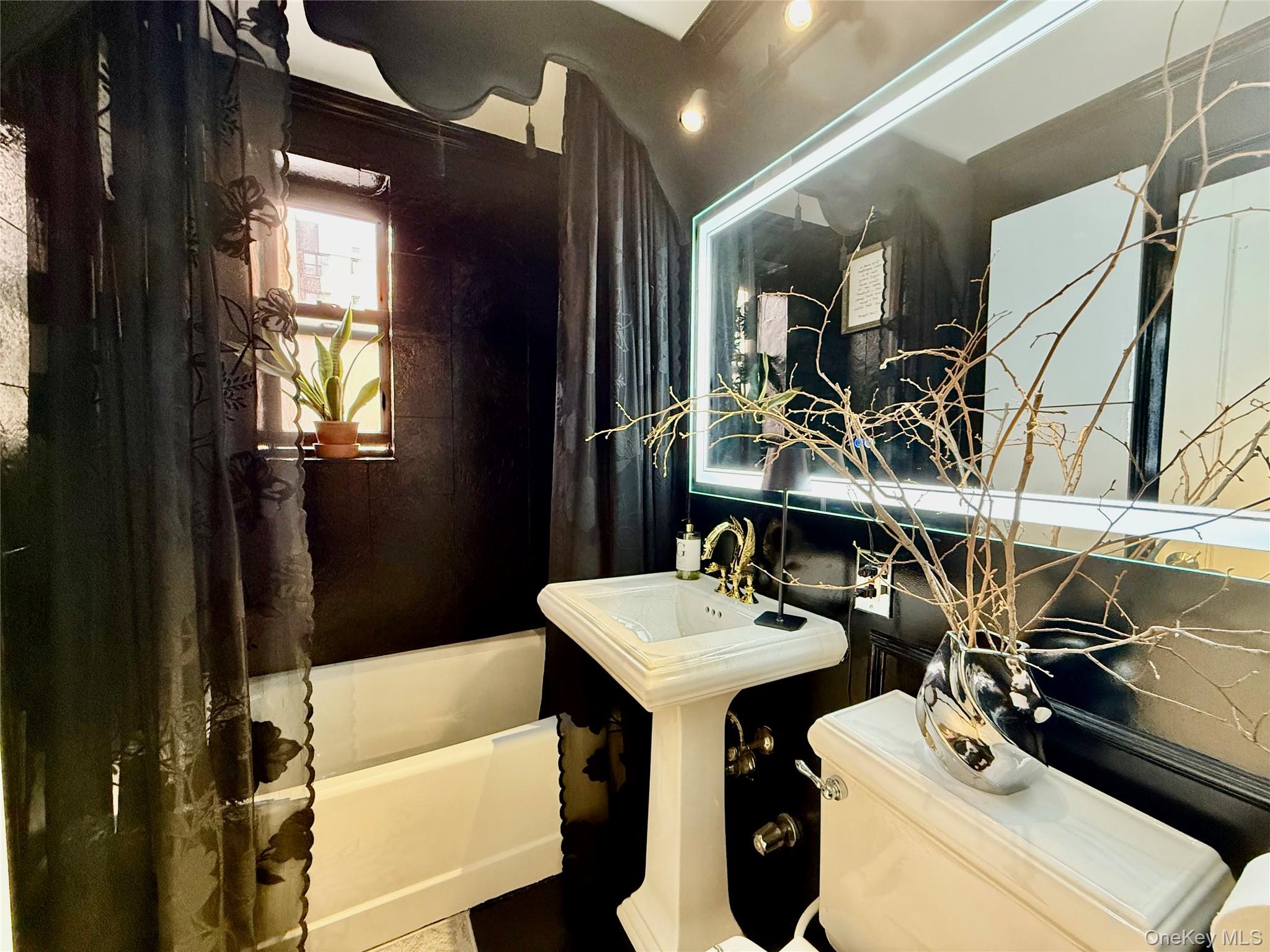 112-25 34th Avenue, Unit 2D Queens, NY 11368 - Photo 18 of 37 a bathroom with a sink a toilet and shower