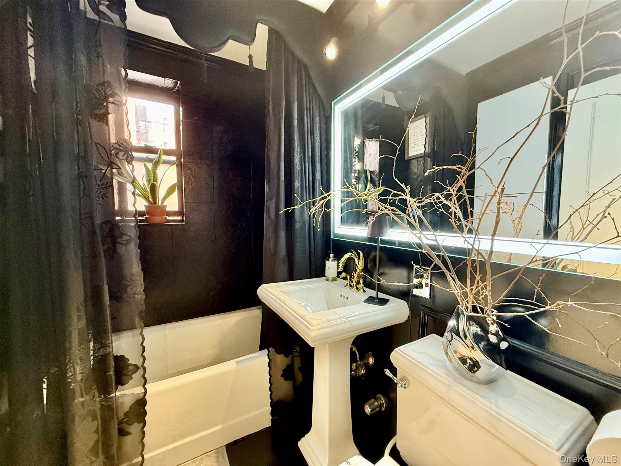 112-25 34th Avenue, Unit 2D Queens, NY 11368 - Photo 20 of 37 a bathroom with a sink toilet and mirror