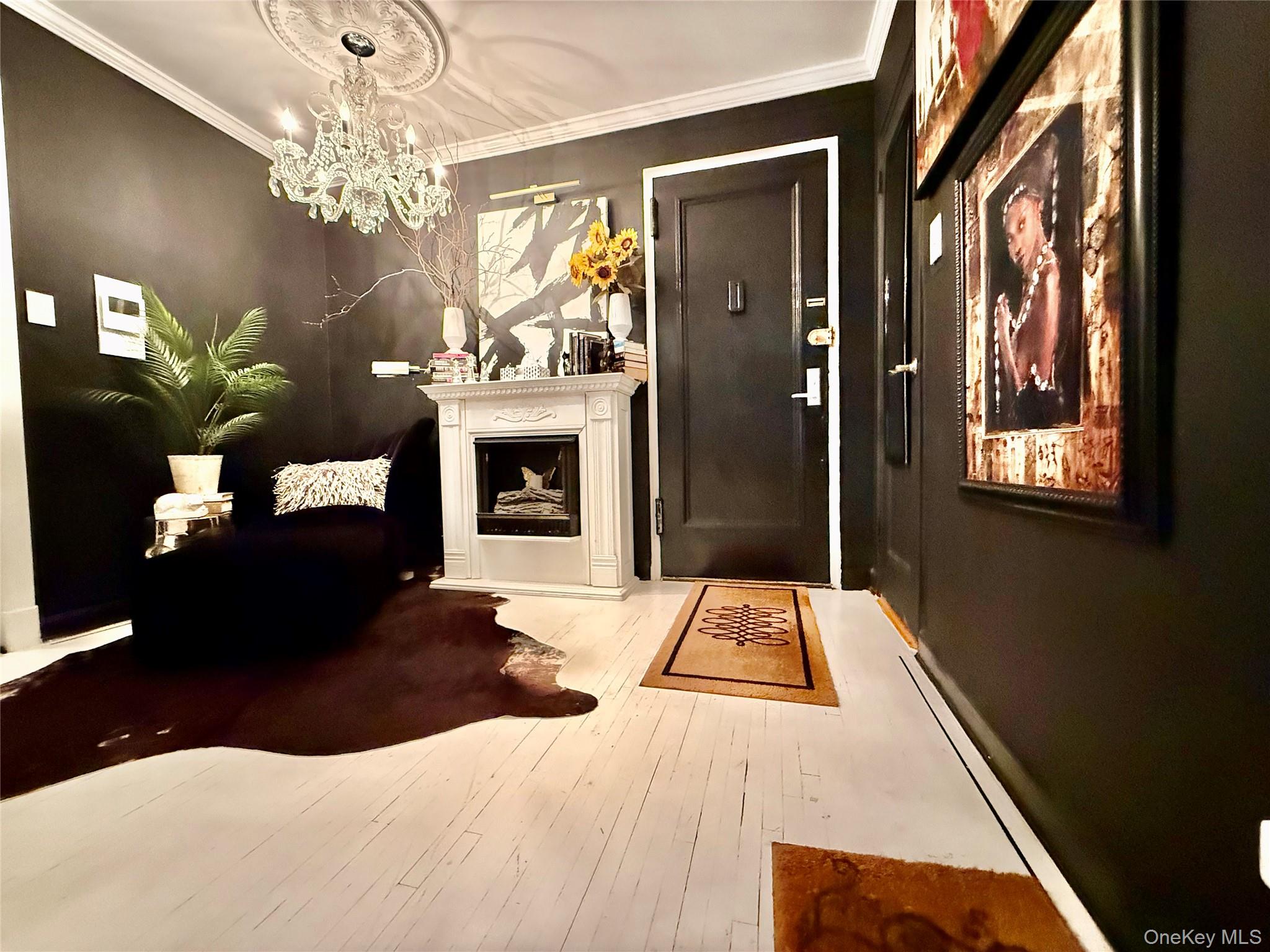 112-25 34th Avenue, Unit 2D Queens, NY 11368 - Photo 2 of 37 a living room with furniture and a fireplace