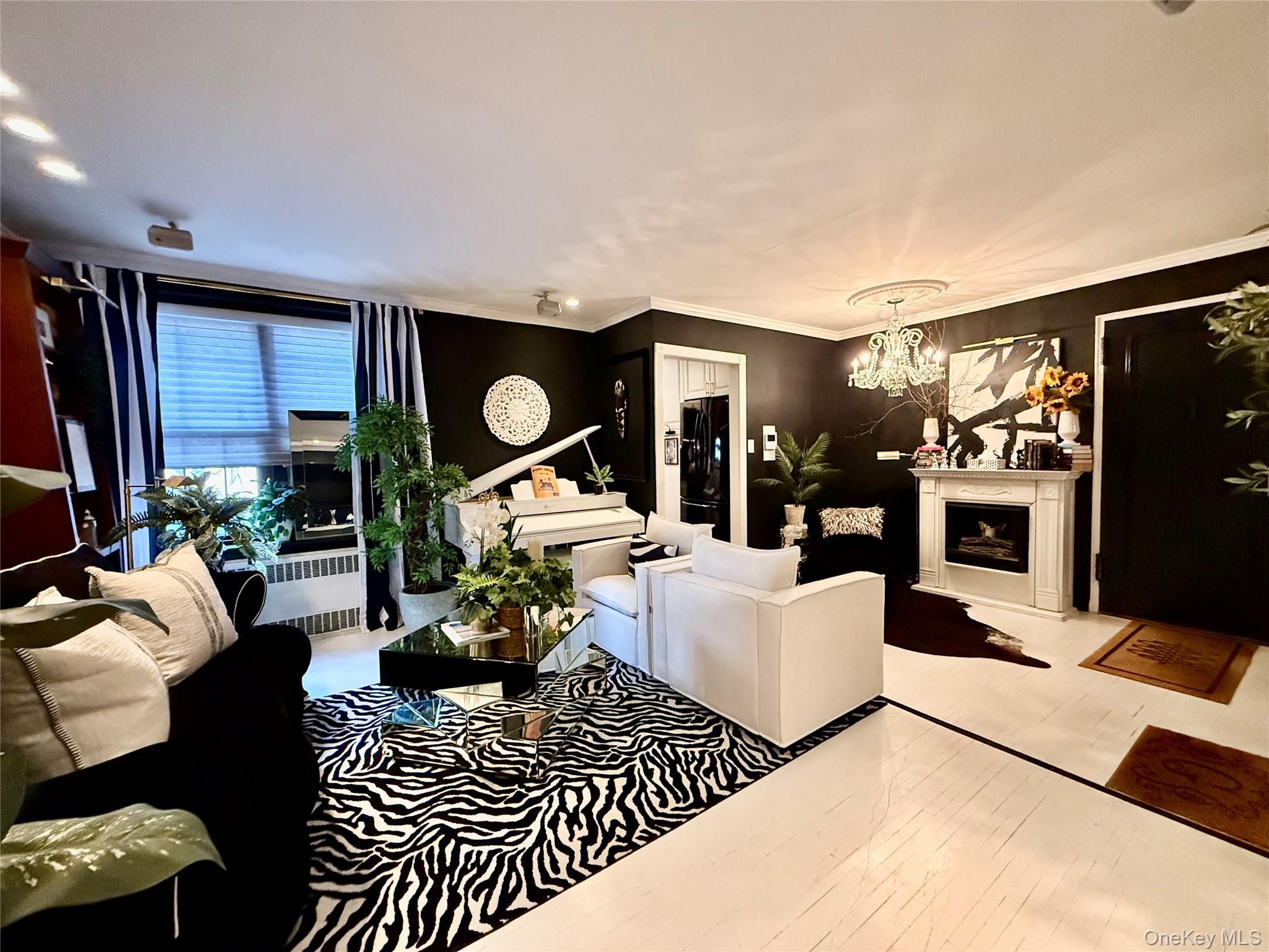 112-25 34th Avenue, Unit 2D Queens, NY 11368 - Photo 3 of 37 a living room with furniture a rug and a flat screen tv