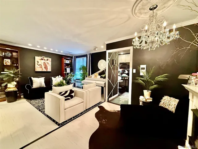 a living room with furniture flowerpot and a chandelier