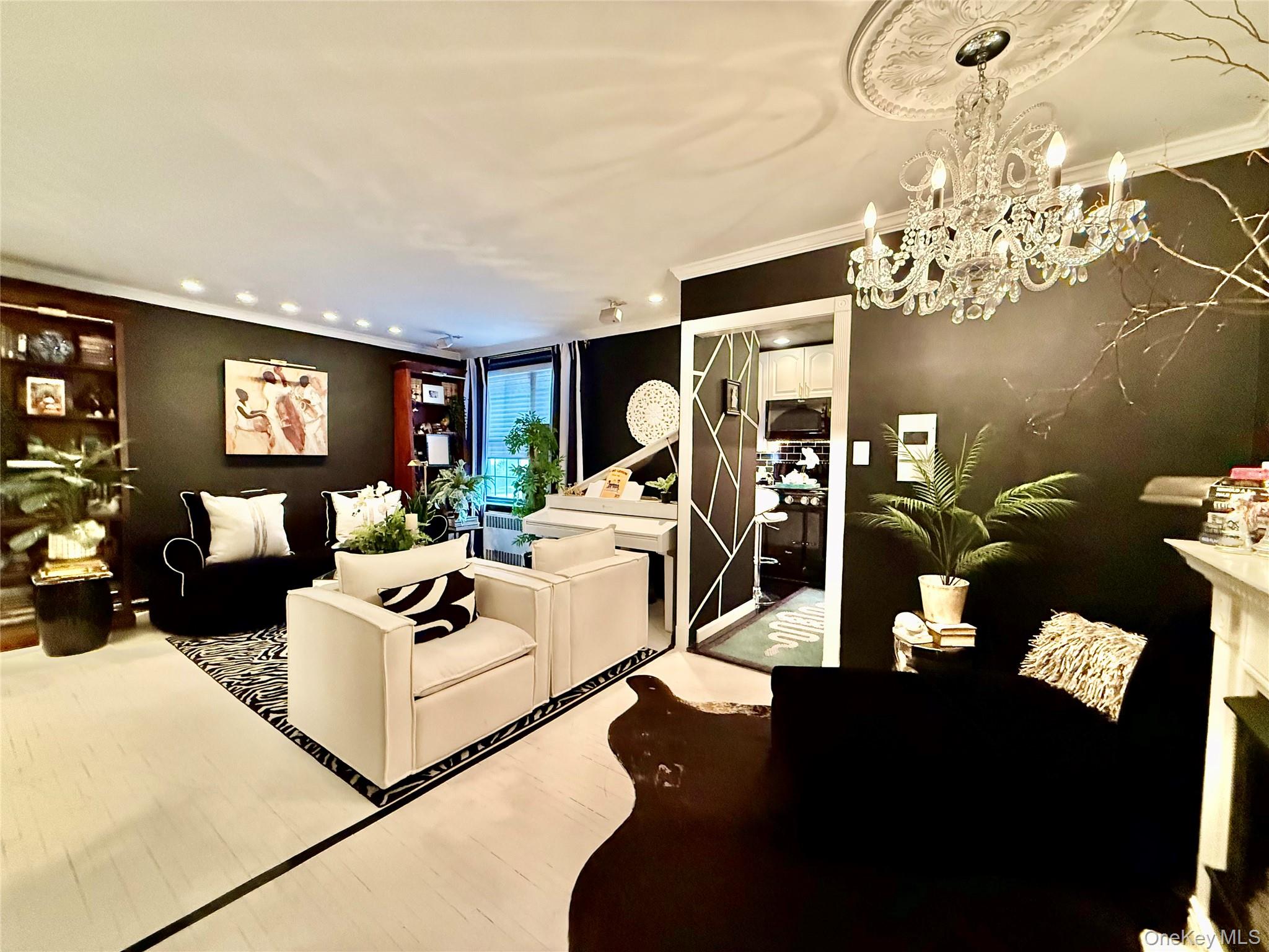 112-25 34th Avenue, Unit 2D Queens, NY 11368 - Photo 4 of 37 a living room with furniture flowerpot and a chandelier