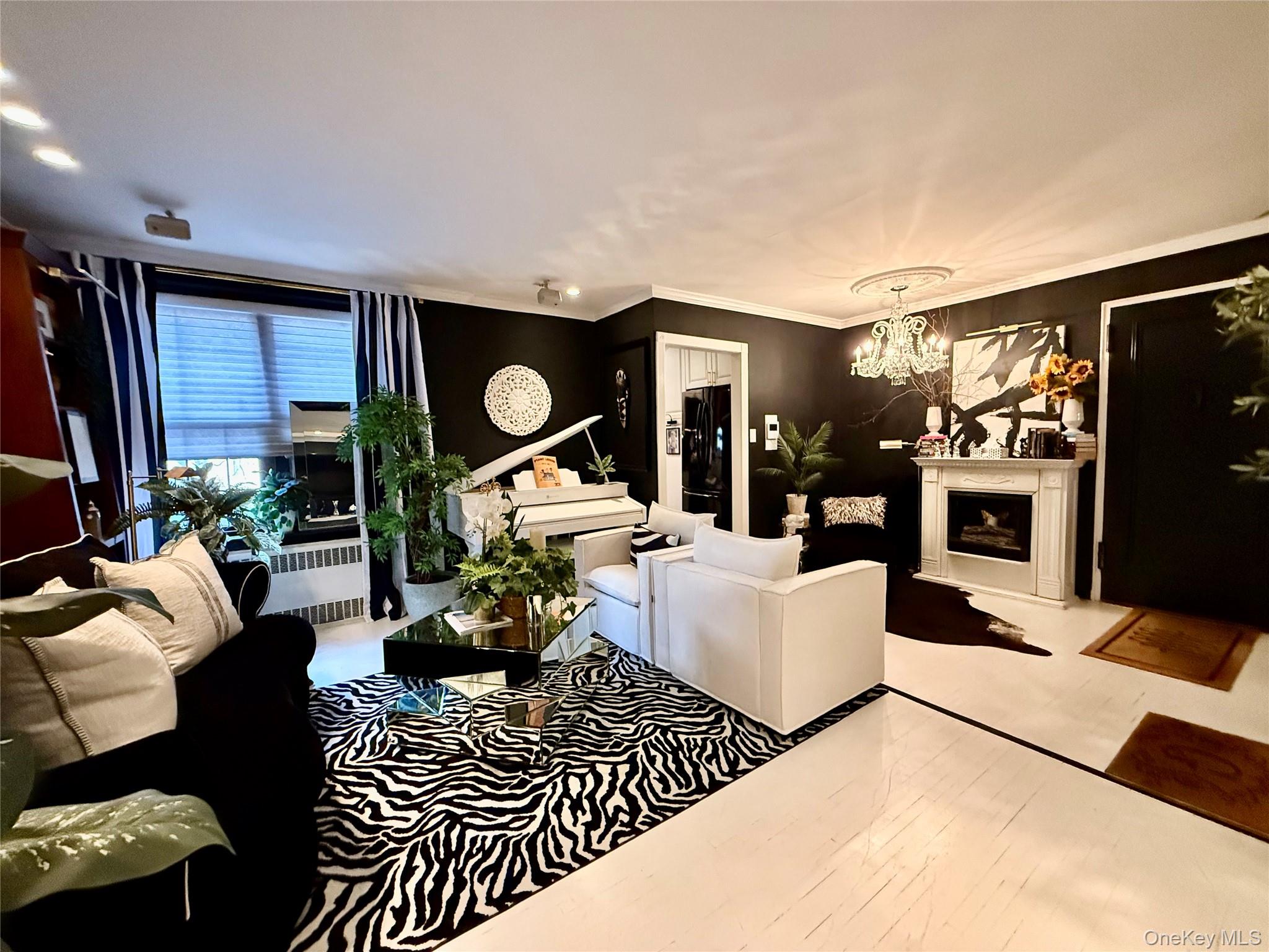 112-25 34th Avenue, Unit 2D Queens, NY 11368 - Photo 7 of 37 a living room with furniture a rug and a flat screen tv