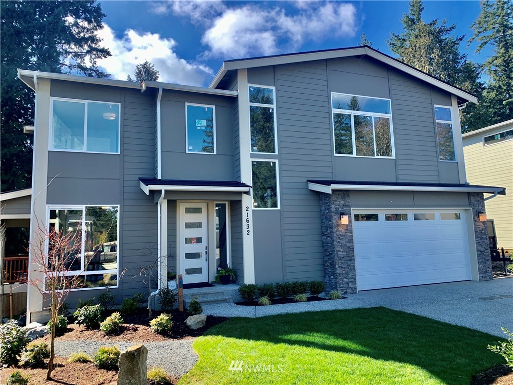 21632 2nd Court Southeast Bothell, WA 98021 - Photo 1 of 21 a front view of a house with a yard garage and outdoor seating