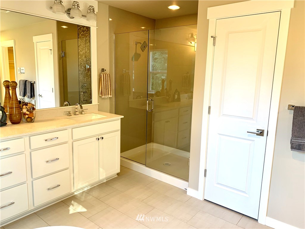 21632 2nd Court Southeast Bothell, WA 98021 - Photo 11 of 21 a bathroom with a shower sink and mirror