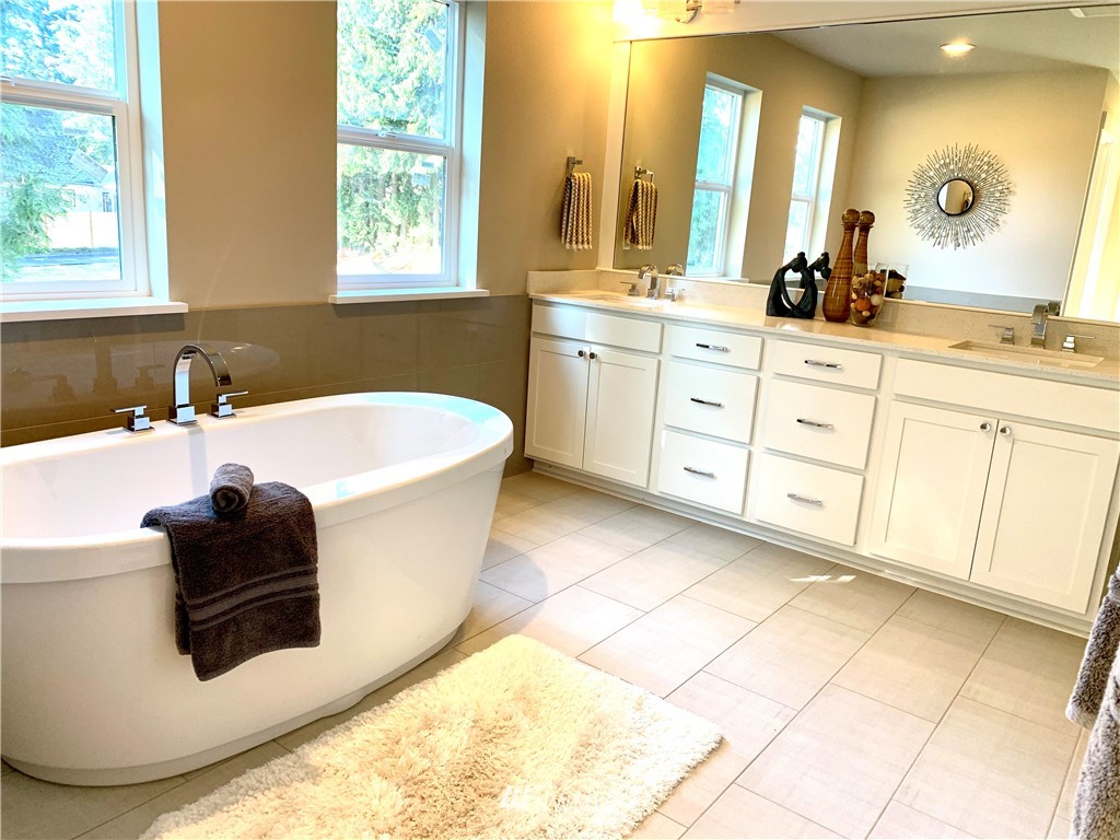 21632 2nd Court Southeast Bothell, WA 98021 - Photo 10 of 21 a bathroom with a tub a sink and a mirror