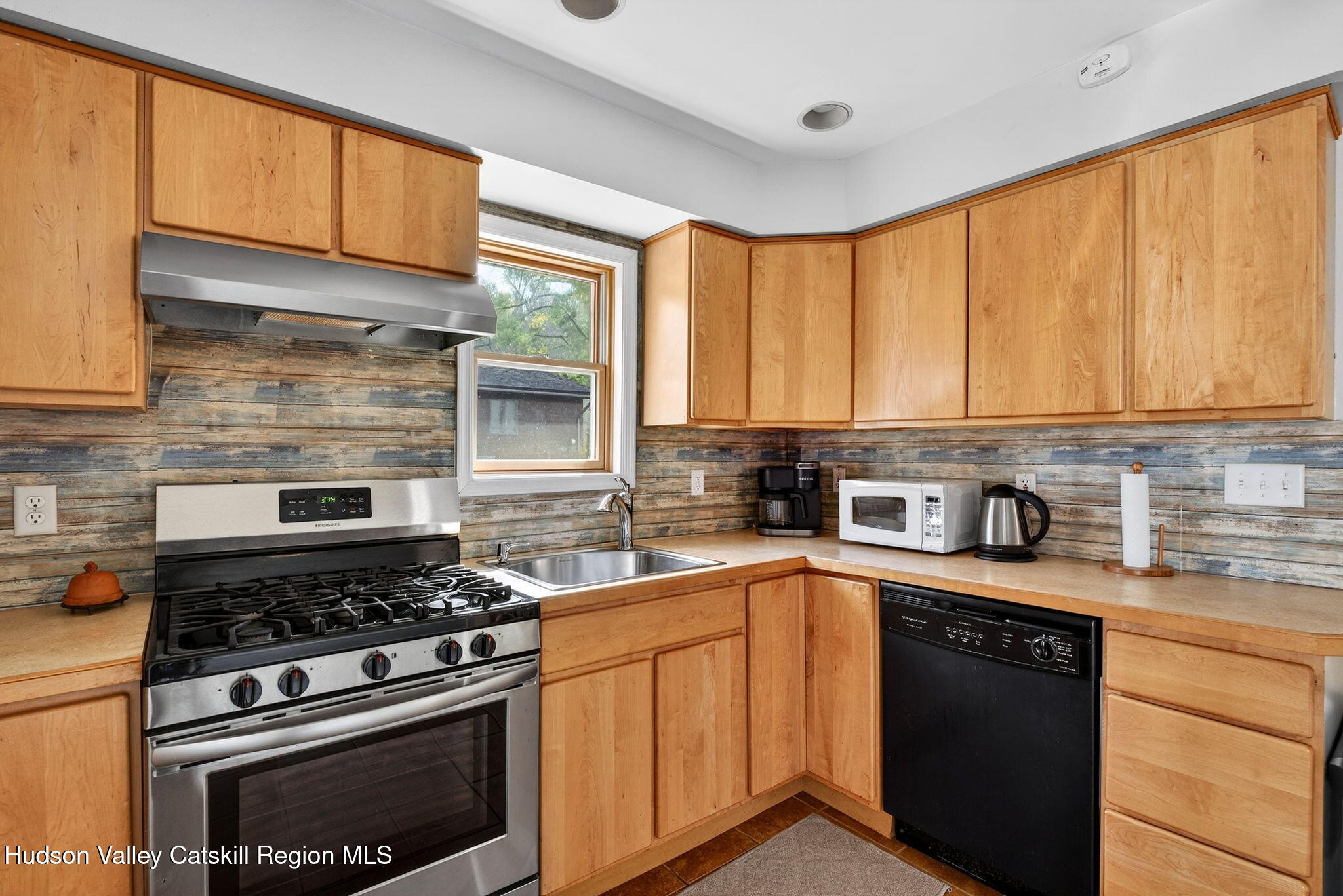 205 Esopus Creek Road Saugerties, NY 12477 - Photo 17 of 56 a kitchen with stainless steel appliances a stove sink and cabinets