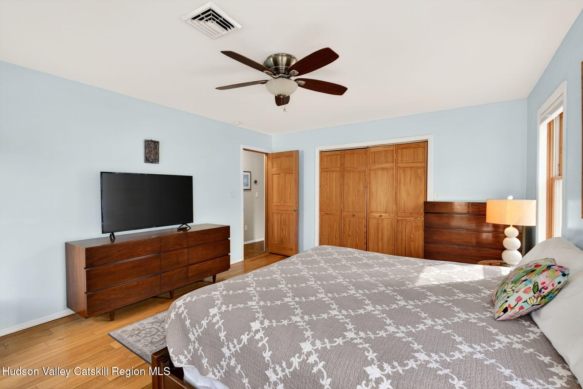 205 Esopus Creek Road Saugerties, NY 12477 - Photo 21 of 56 a bedroom with a bed and a flat screen tv