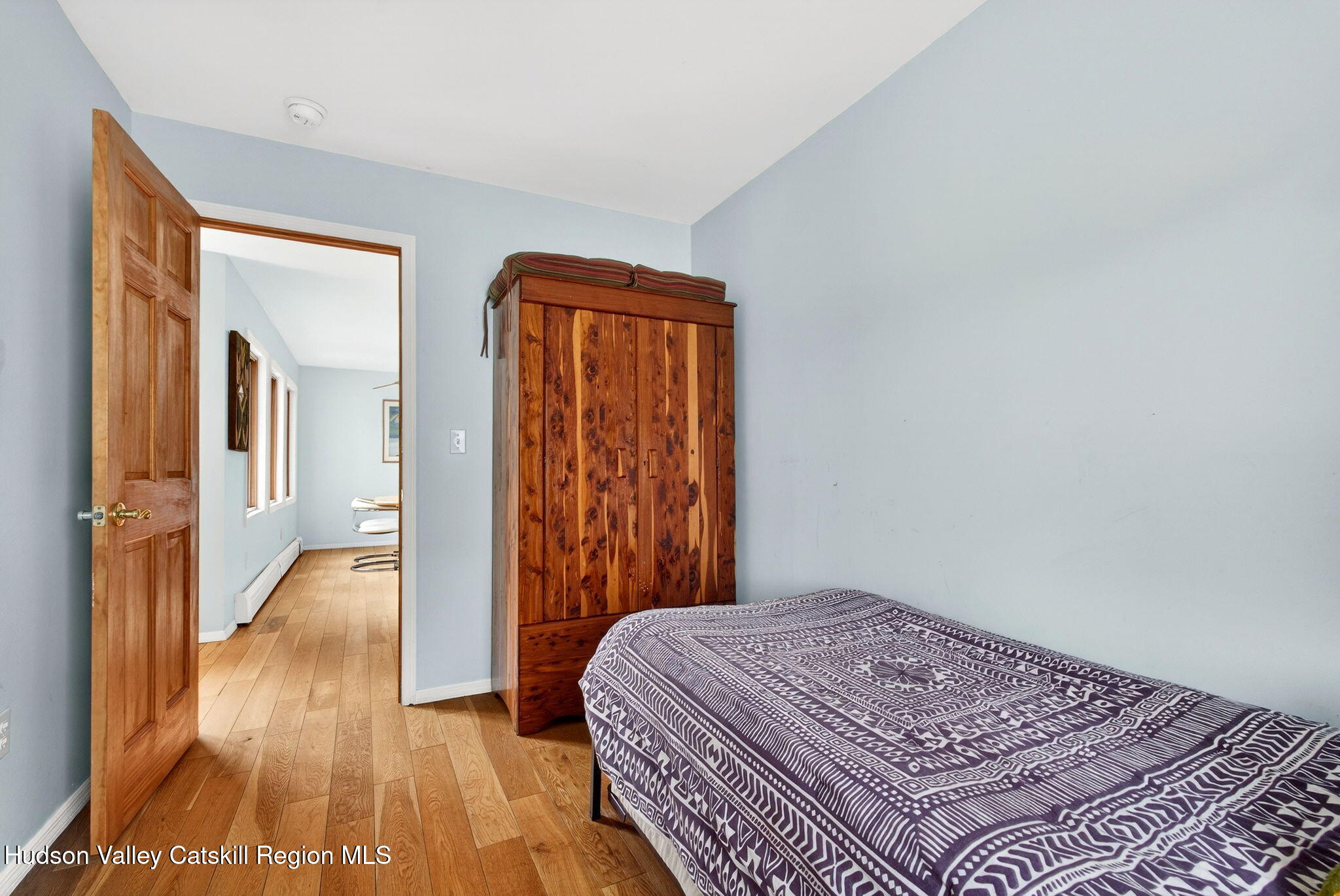 205 Esopus Creek Road Saugerties, NY 12477 - Photo 30 of 56 a bedroom with a bed and wooden floor