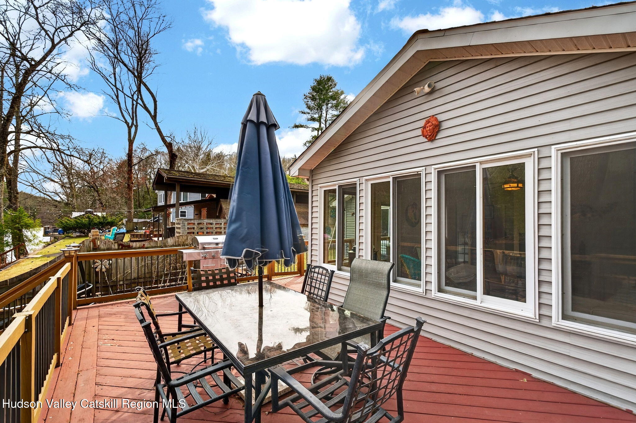 205 Esopus Creek Road Saugerties, NY 12477 - Photo 32 of 56 a view of a patio with couches table and chairs and wooden floor