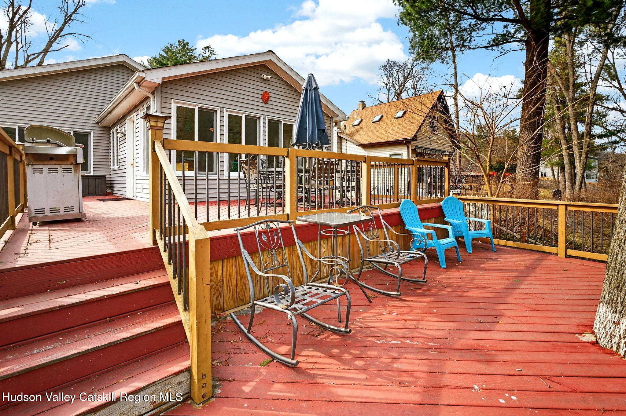205 Esopus Creek Road Saugerties, NY 12477 - Photo 33 of 56 a view of a house with wooden deck and furniture