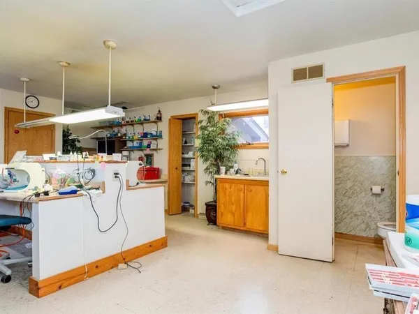 a kitchen with a sink appliances and cabinets