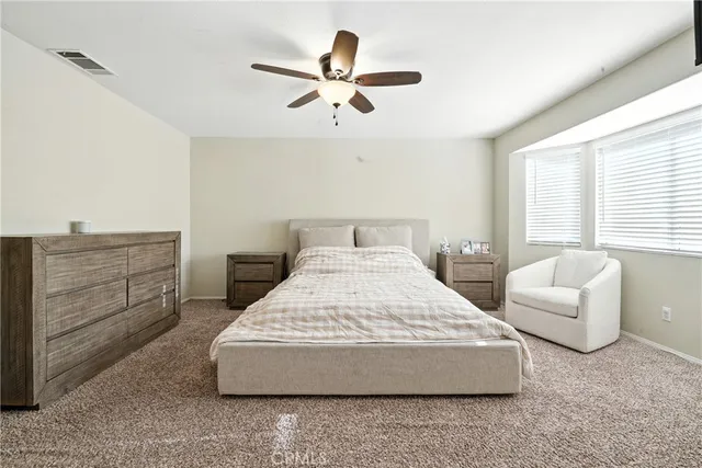 a bedroom with a bed and couch