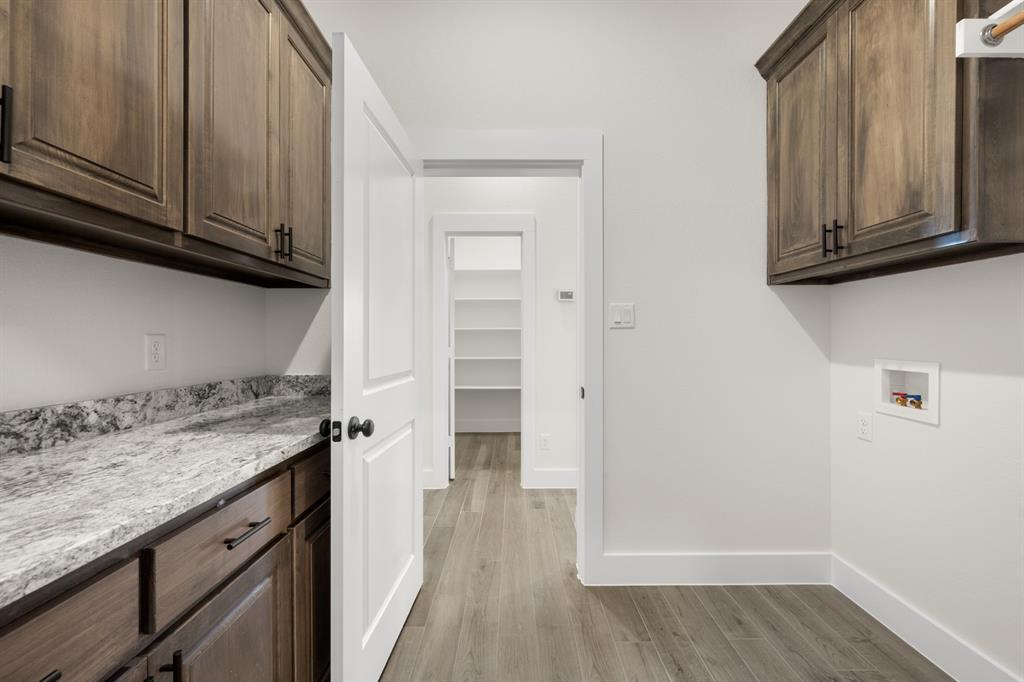 4867 Prairie Sky Lane DISH, TX 76247 - Photo 26 of 27 a view of a kitchen cabinets and wooden floor