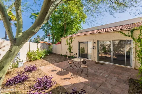 a view of a patio with table and chairs and potted plants
